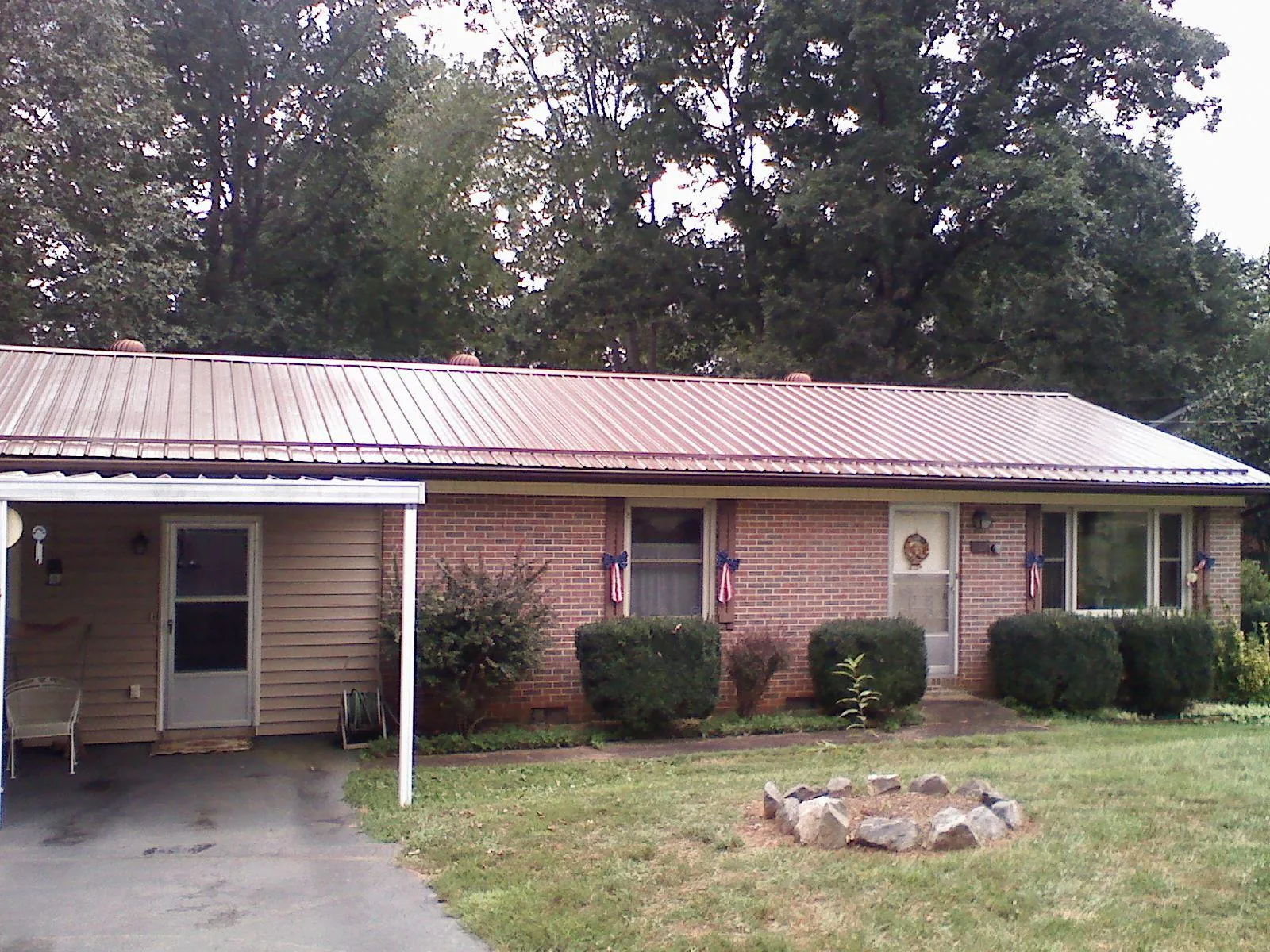 Bronze metal roof and carport on a brick ranch home — Roof Repair work by our crew in Weatogue
